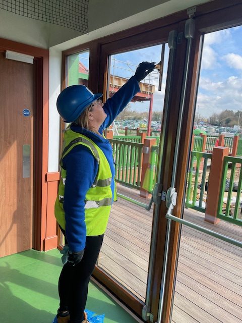 Woman cleaning window indoors